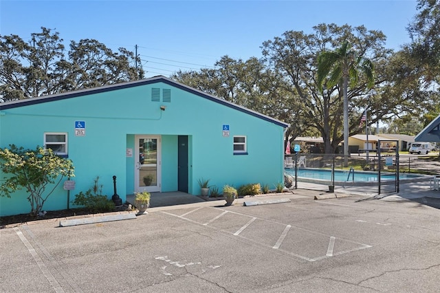 view of building exterior with a fenced in pool