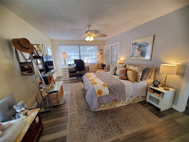 bedroom with dark hardwood / wood-style flooring, a closet, and ceiling fan