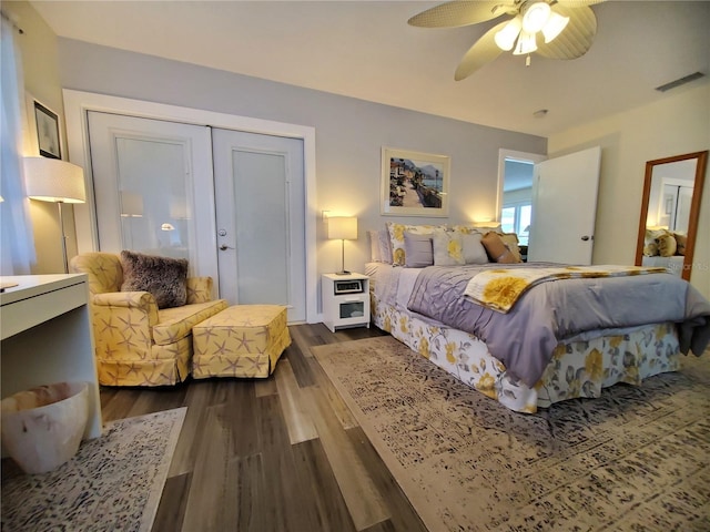 bedroom with dark hardwood / wood-style flooring, a closet, and ceiling fan