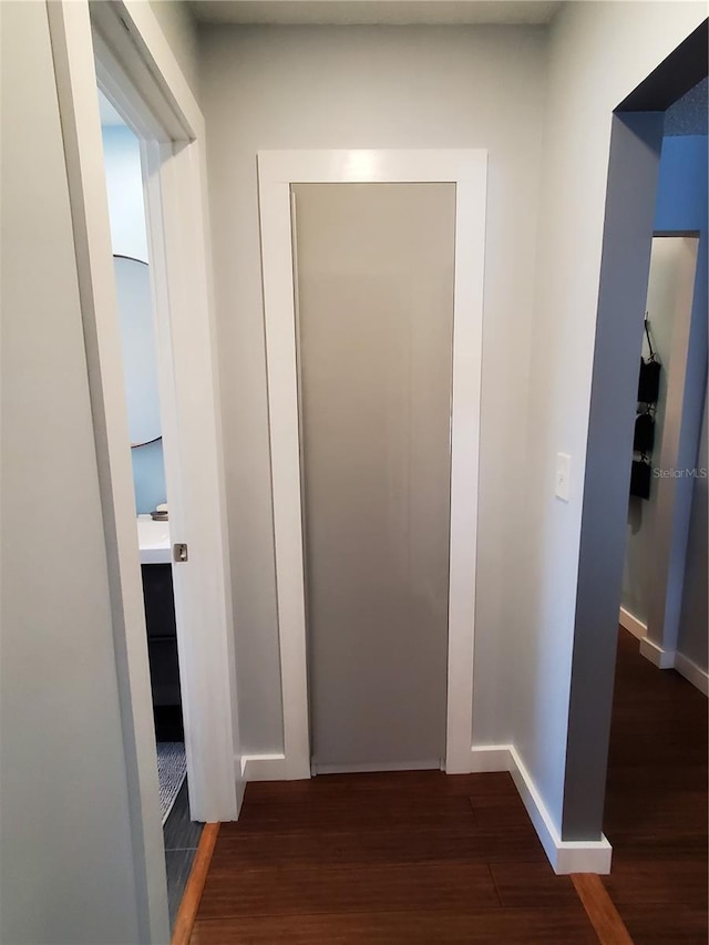 hallway with dark hardwood / wood-style floors