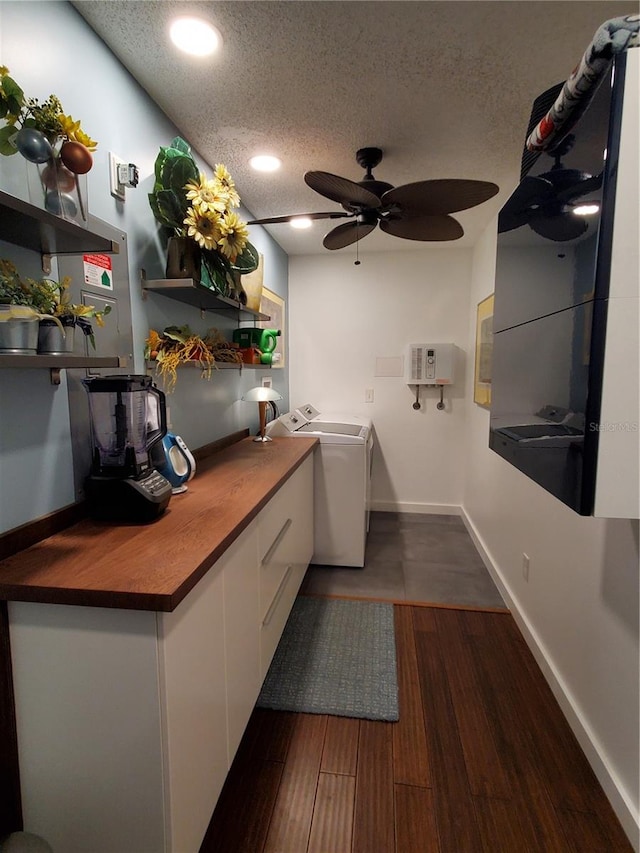 kitchen with white cabinetry, ceiling fan, dark hardwood / wood-style flooring, a textured ceiling, and washer / dryer