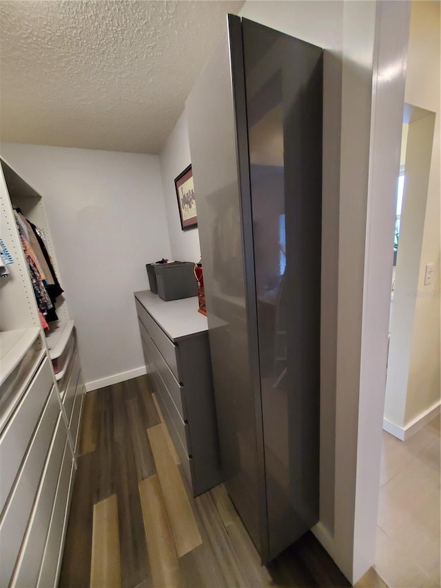 spacious closet featuring dark hardwood / wood-style flooring