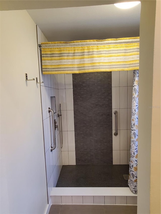 bathroom featuring tile patterned flooring and curtained shower