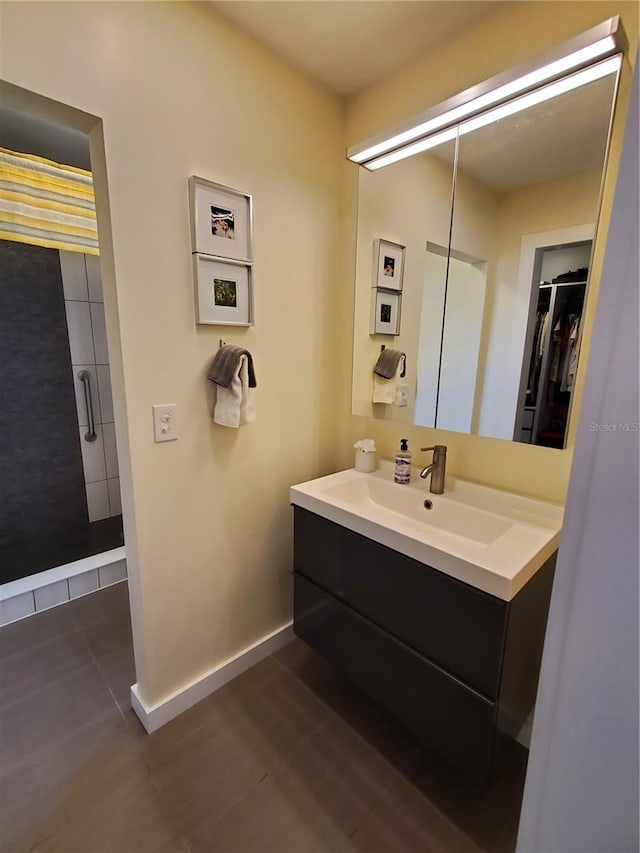 bathroom featuring tile patterned floors, vanity, and tiled shower