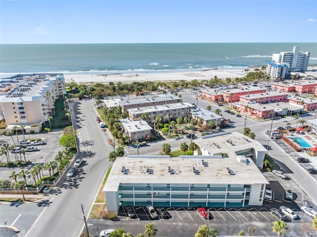 drone / aerial view featuring a water view and a beach view