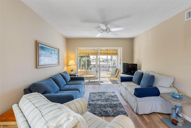 living room with ceiling fan and light hardwood / wood-style floors