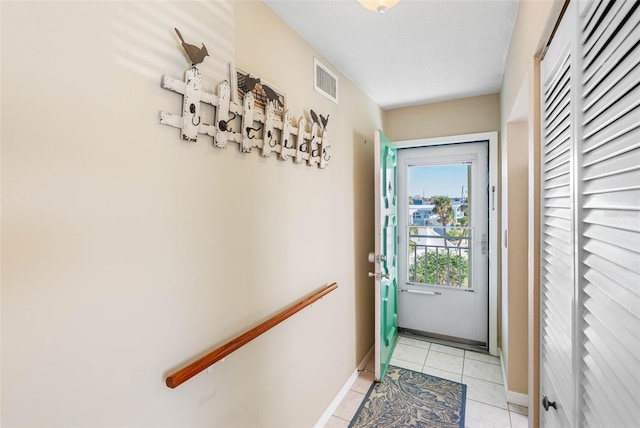 entryway with light tile patterned floors