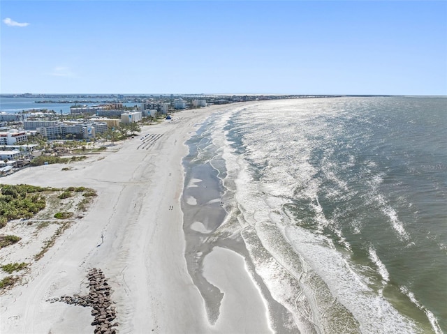 drone / aerial view featuring a water view and a beach view