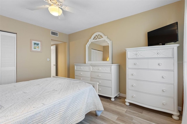 bedroom featuring ceiling fan, light wood-type flooring, and a closet