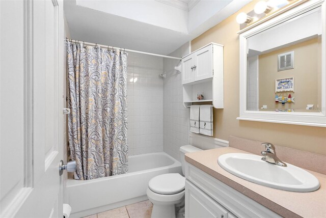 full bathroom featuring toilet, vanity, tile patterned floors, and shower / bath combo with shower curtain