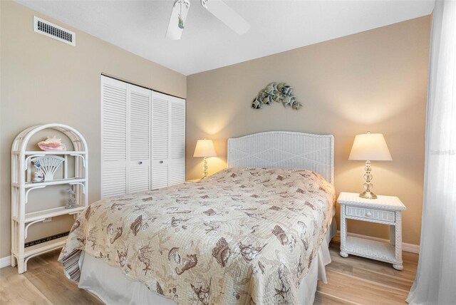 bedroom with ceiling fan, a closet, and light hardwood / wood-style floors