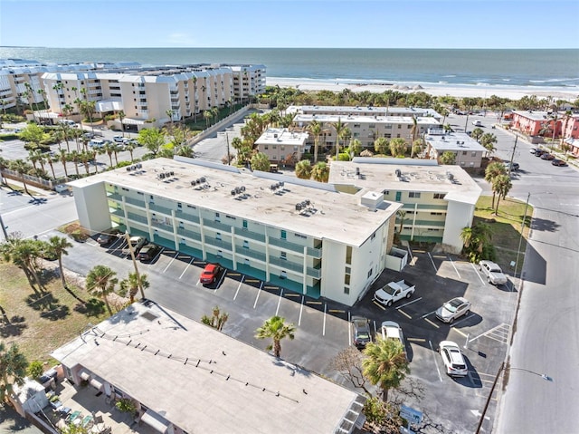 drone / aerial view featuring a view of the beach and a water view