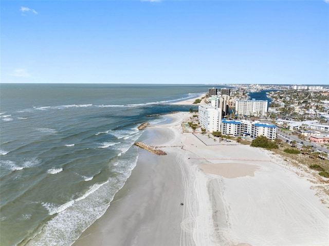 birds eye view of property featuring a water view and a beach view