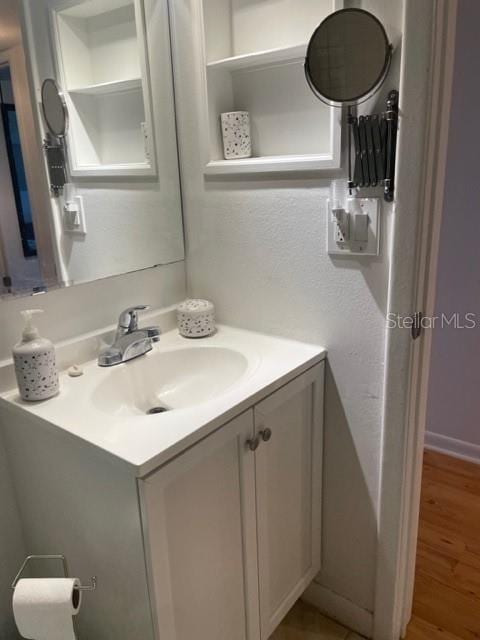 bathroom with hardwood / wood-style flooring and vanity