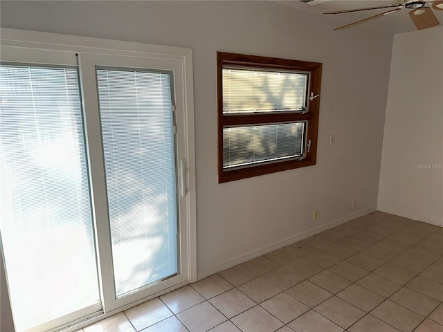 empty room with light tile patterned floors and ceiling fan