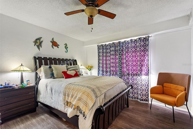 bedroom with ceiling fan, dark hardwood / wood-style flooring, and a textured ceiling