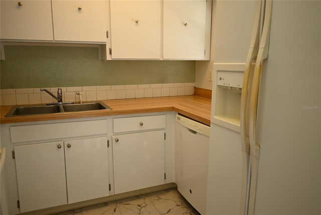 kitchen with white cabinetry, white appliances, and sink