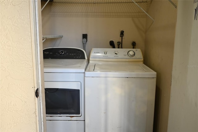 clothes washing area with separate washer and dryer