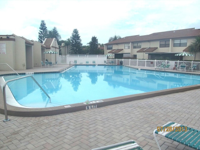 view of swimming pool with a patio area