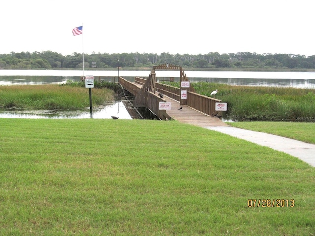 exterior space featuring a lawn and a water view