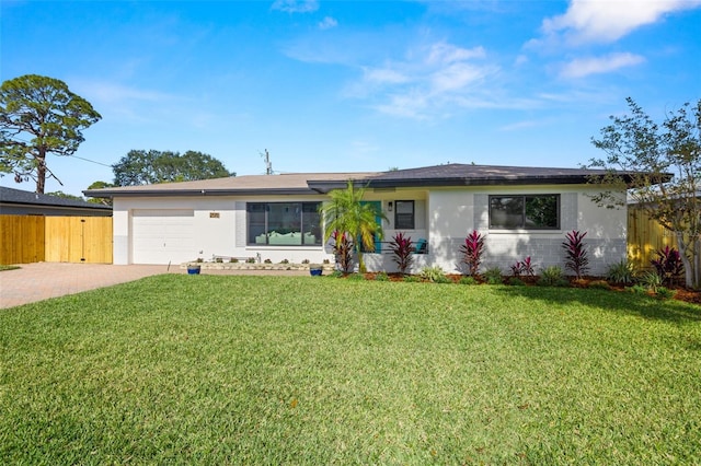 ranch-style home with a garage and a front lawn