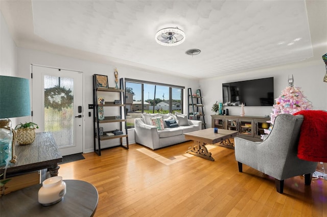 living room featuring a healthy amount of sunlight and light hardwood / wood-style flooring