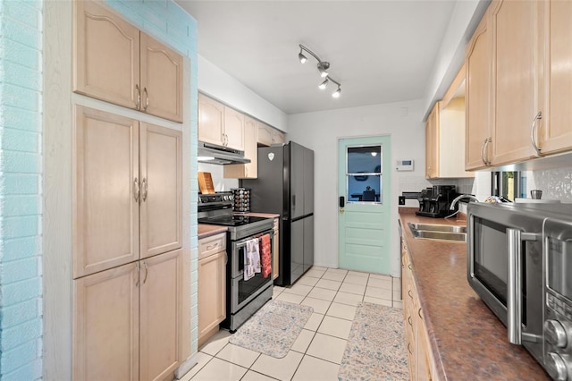 kitchen with backsplash, black fridge, stainless steel range with electric stovetop, sink, and light brown cabinets