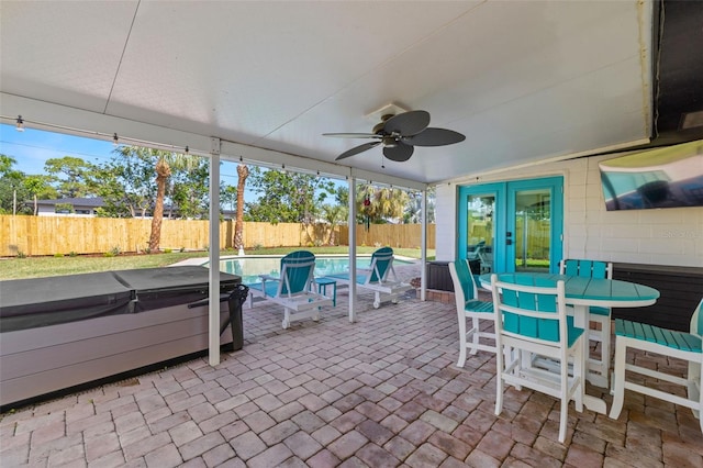 sunroom / solarium with french doors, vaulted ceiling, ceiling fan, and plenty of natural light