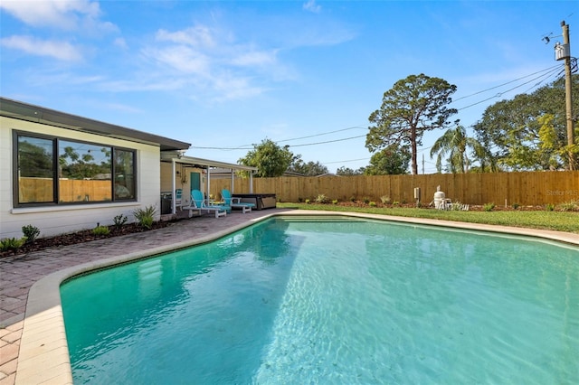 view of swimming pool with a patio and a hot tub