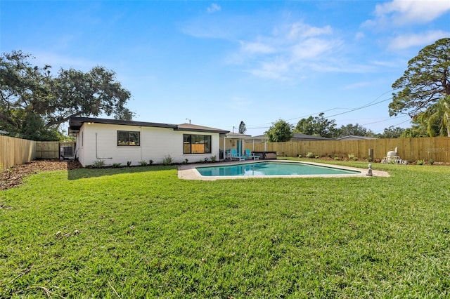 back of house with a fenced in pool and a lawn