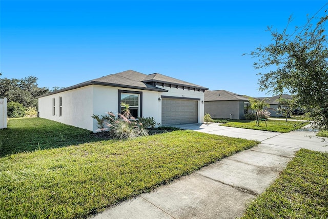 view of front of property featuring a garage and a front yard