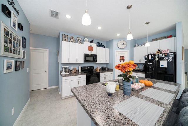 kitchen with black appliances, pendant lighting, white cabinets, and a kitchen island