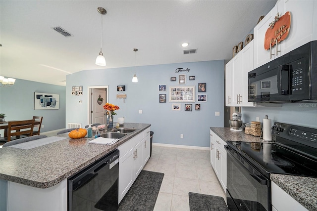 kitchen featuring pendant lighting, a center island with sink, white cabinets, and black appliances