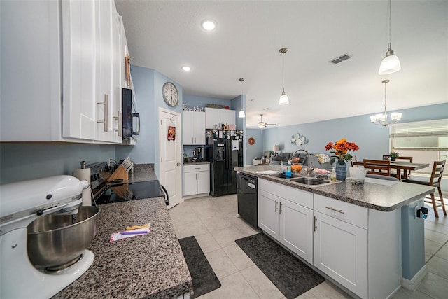 kitchen featuring ceiling fan with notable chandelier, a kitchen island with sink, sink, black appliances, and white cabinetry