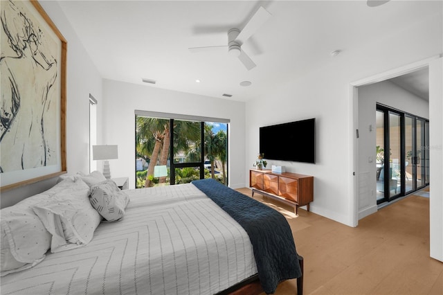 bedroom featuring ceiling fan, light hardwood / wood-style floors, and access to outside