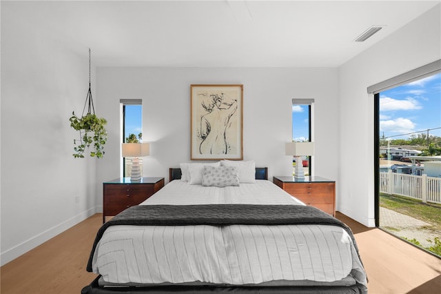 bedroom featuring access to outside and light hardwood / wood-style floors