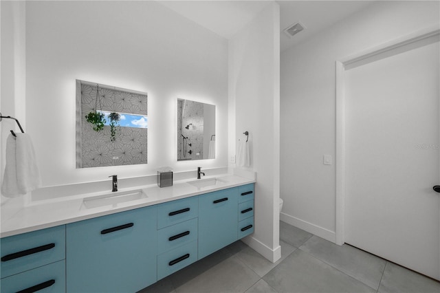 bathroom with a shower, tile patterned floors, and vanity