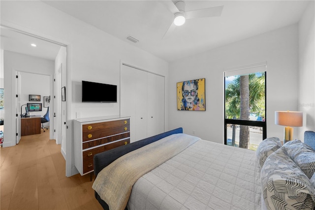 bedroom featuring ceiling fan, a closet, and light hardwood / wood-style flooring