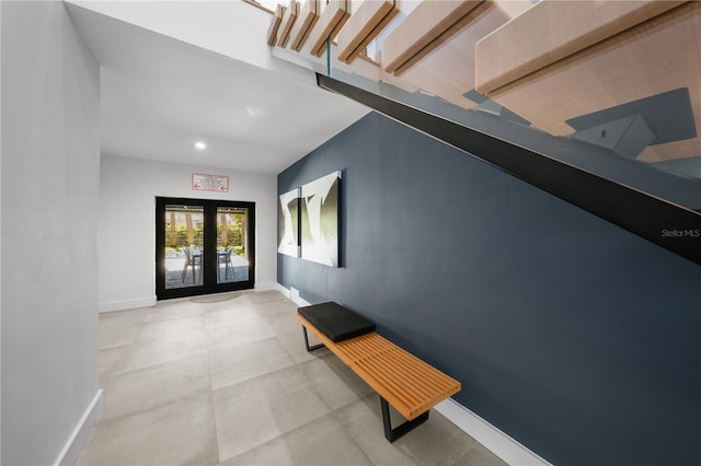 hallway with french doors and concrete flooring