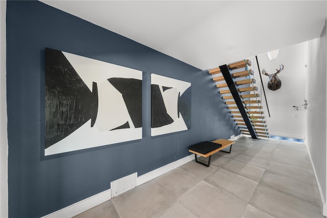 staircase featuring concrete flooring