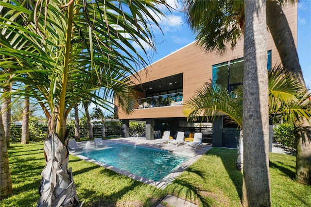 view of pool with a yard and a patio