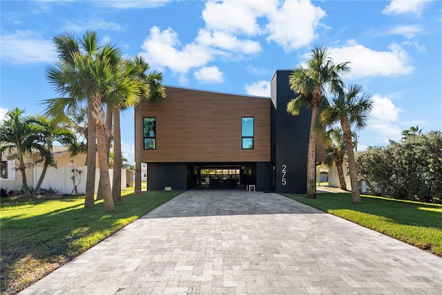 view of front facade with a carport and a front yard