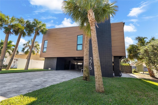 exterior space featuring a carport and a front yard