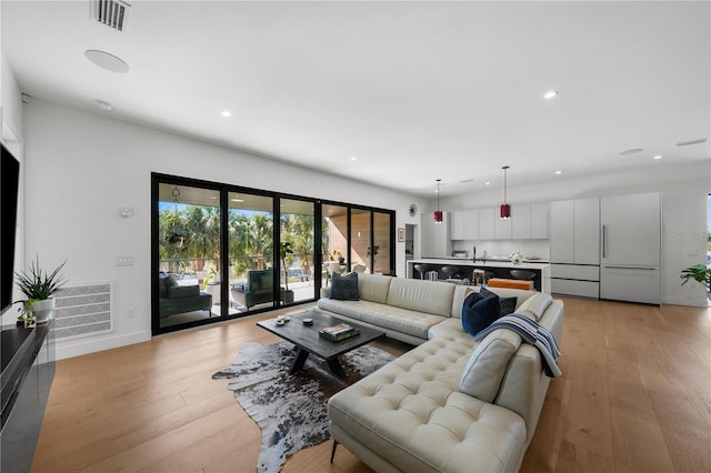 living room with light hardwood / wood-style flooring