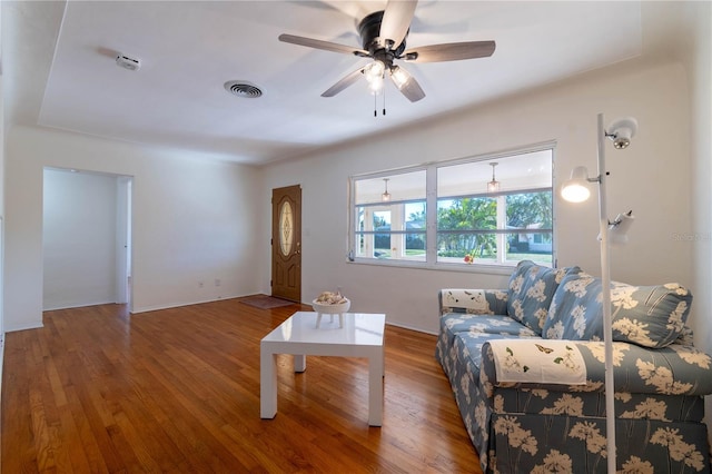 living room featuring hardwood / wood-style floors and ceiling fan