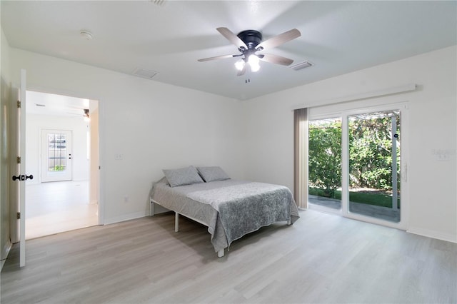 bedroom featuring access to outside, light hardwood / wood-style floors, and ceiling fan