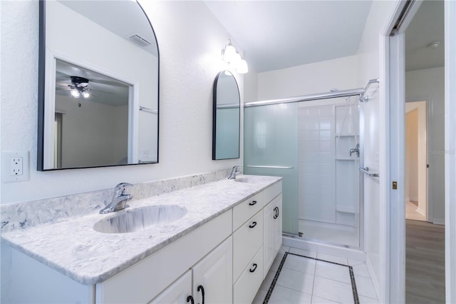 bathroom featuring vanity, a shower with door, tile patterned floors, and ceiling fan