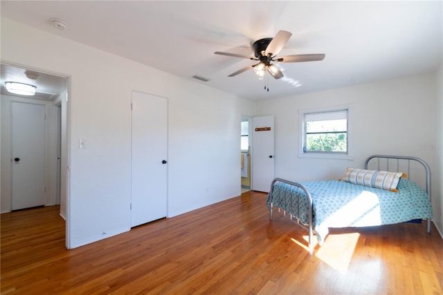 bedroom with hardwood / wood-style flooring and ceiling fan