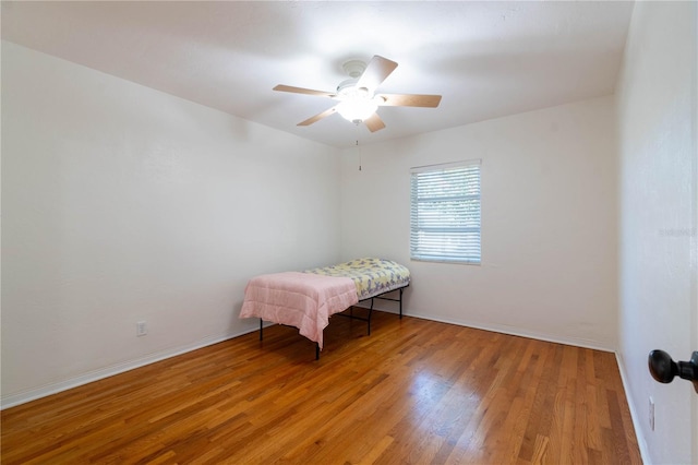 unfurnished bedroom with ceiling fan and light hardwood / wood-style floors