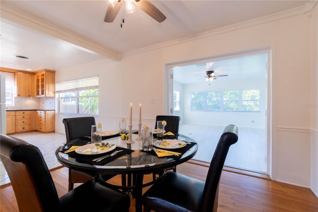 dining room featuring ceiling fan, beam ceiling, light wood-type flooring, and ornamental molding